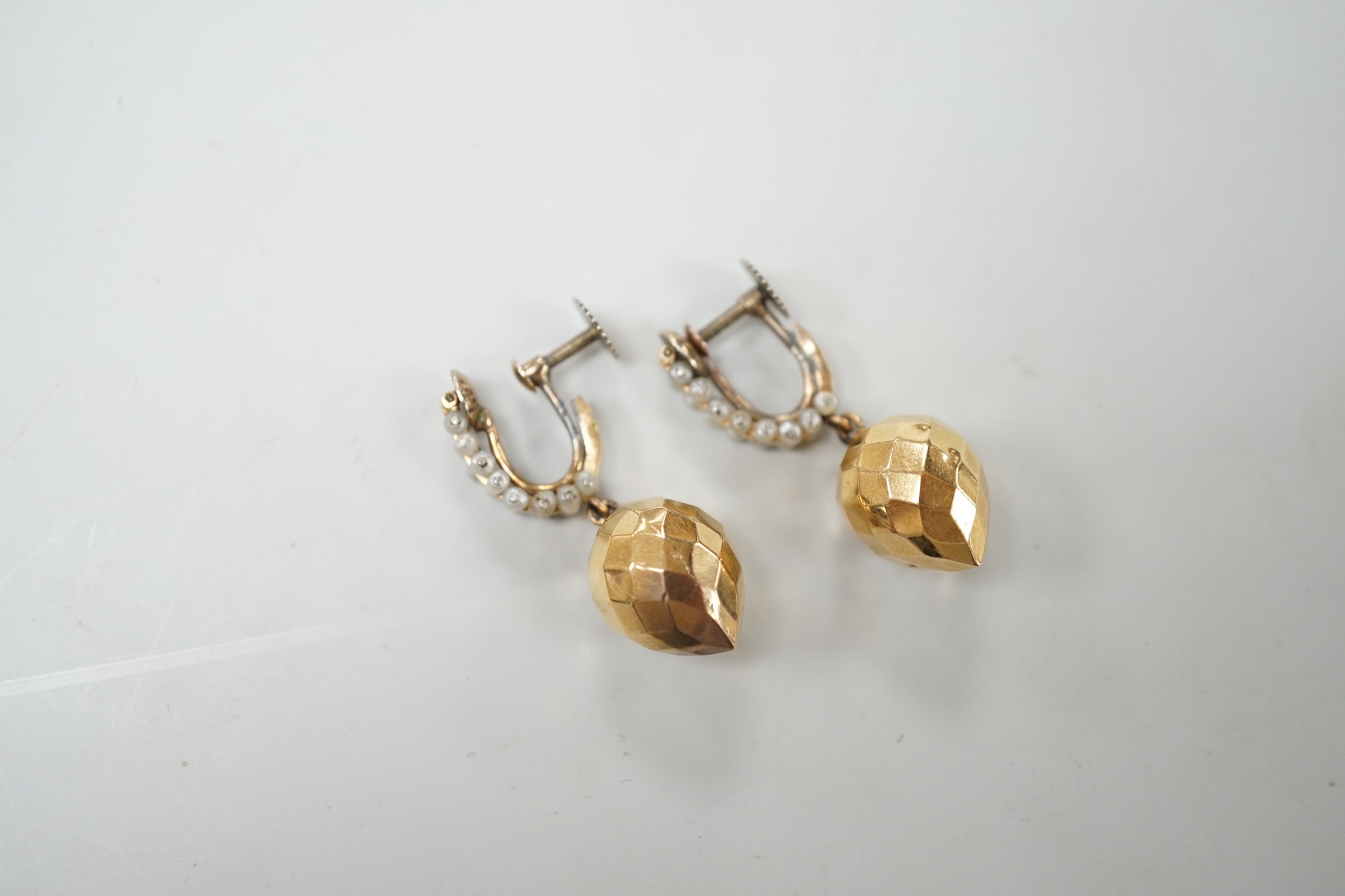 A pair of Victorian yellow metal and seed pearl 'facetted' drop ear clips, overall 34mm, gross weight 5.2 grams.